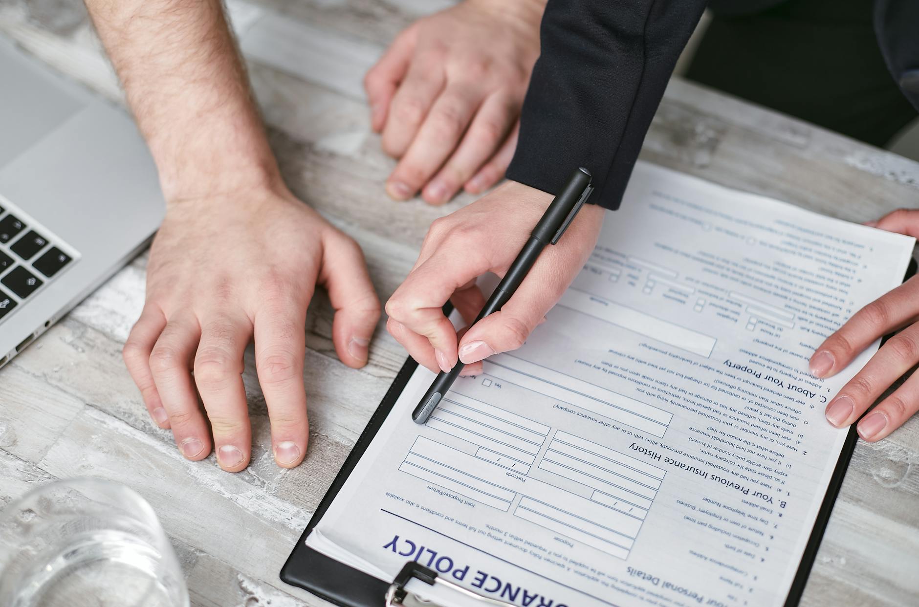 a person holding a black pen